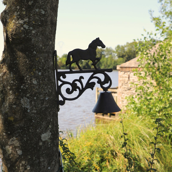 Cloche murale en fonte marron surmontée d'un cheval